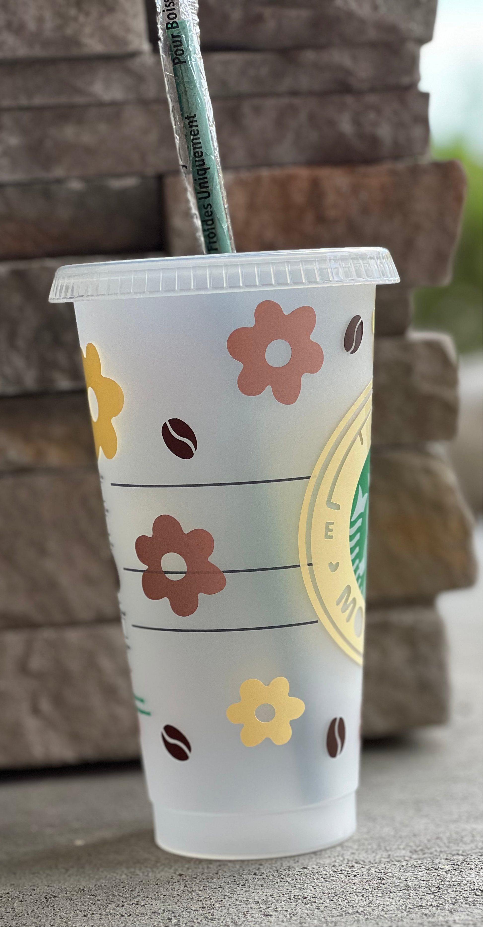 Plastic cup with floral design and straw 
