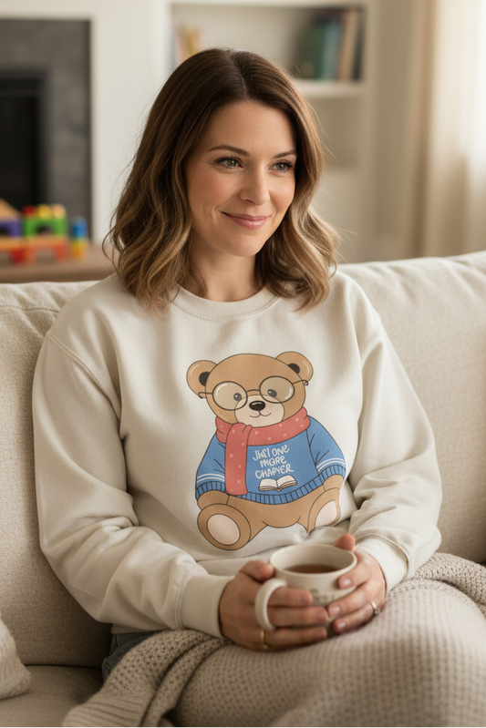 Mom wearing "Just one more chapter" bear sweatshirt
