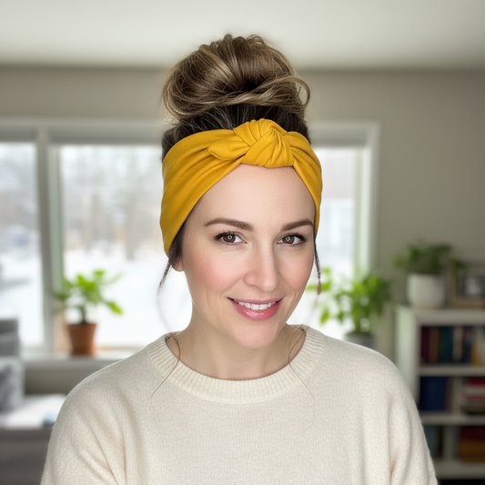 Woman wearing mustard yellow headband with messy bun